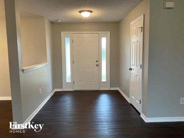 a empty living room with a white door