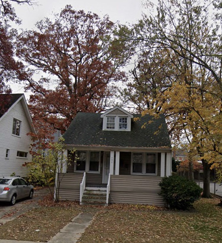 a small white house with a gray roof