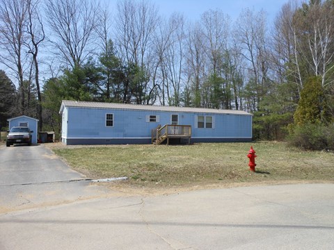 A blue house with a red fire hydrant in front of it.