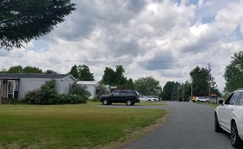 a row of cars parked on the side of a road
