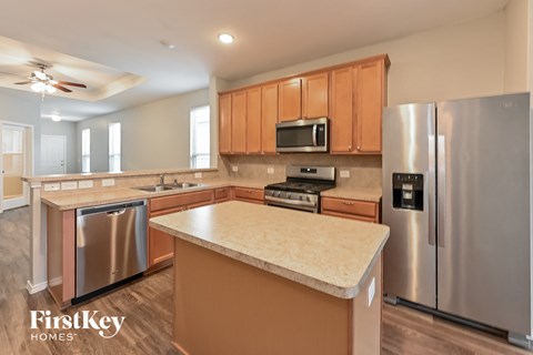 A kitchen with a stainless steel refrigerator and a countertop.