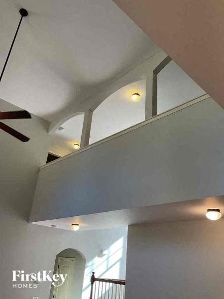 a living room with a white ceiling and a ceiling fan