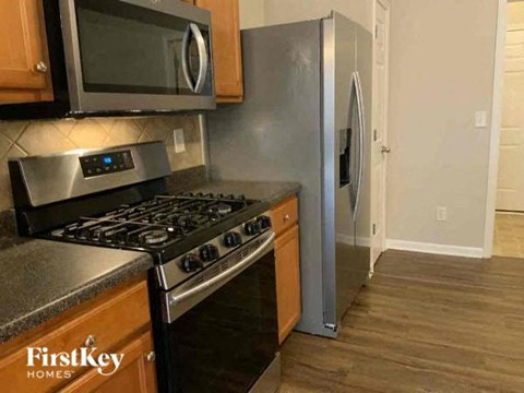 a kitchen with a stove and a refrigerator