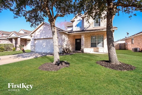 a home with two trees in the front yard