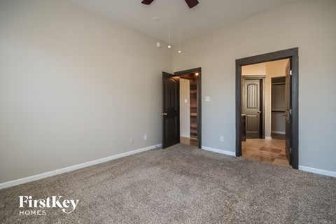 a living room with a carpeted floor and a door to a hallway and a