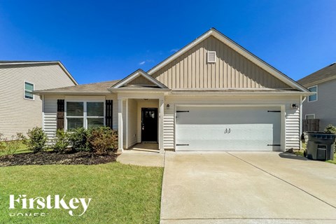 A house with a garage and a driveway is for sale.