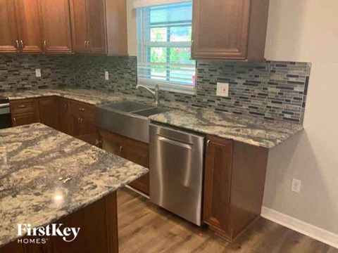 a kitchen with marble counter tops and stainless steel appliances