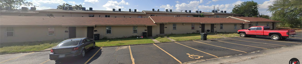 a car parked in a parking lot in front of a building