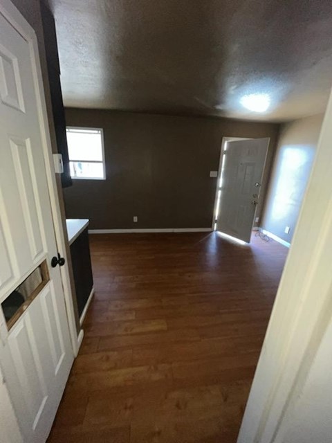 a empty room with a wooden floor and a door