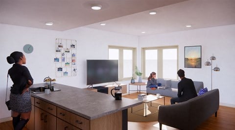people in an office and living room with a desk and a tv