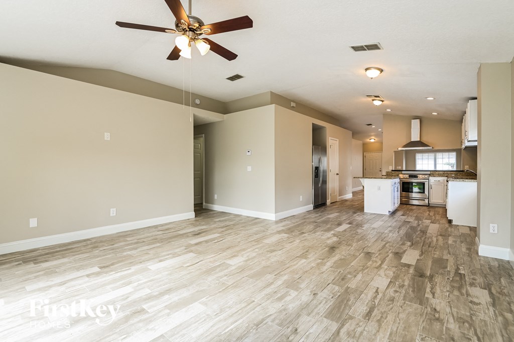 the living room is open to the kitchen and dining area