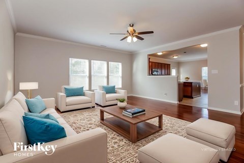 A living room with a white couch and a coffee table.