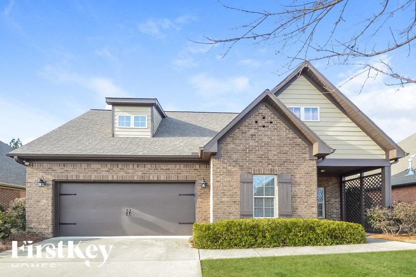 A house with a garage and a driveway in front.