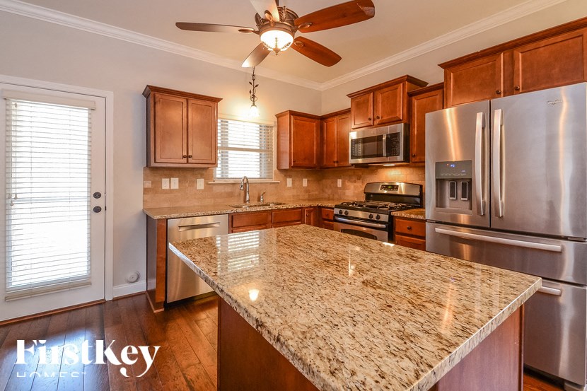 A kitchen with granite countertops and stainless steel appliances.