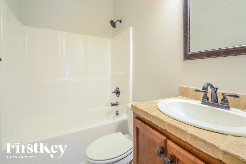 A bathroom with a white toilet, a sink, and a bathtub.