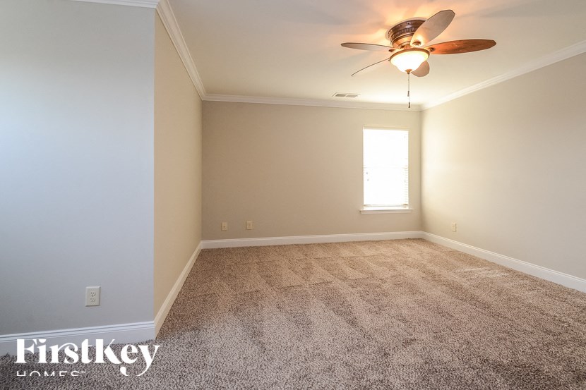 A room with a fan and a window.