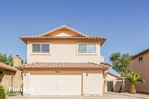 a white house with a white garage door in front of it