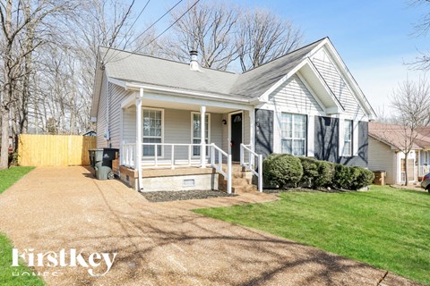 A house with a grey roof and a porch.