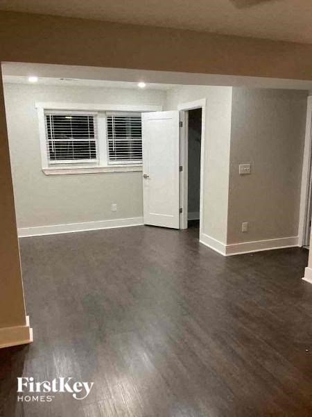an empty living room with a hard wood floor