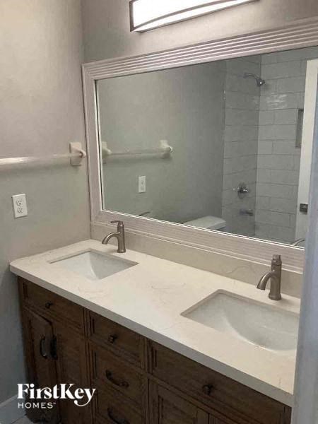 a bathroom with two sinks and a large mirror