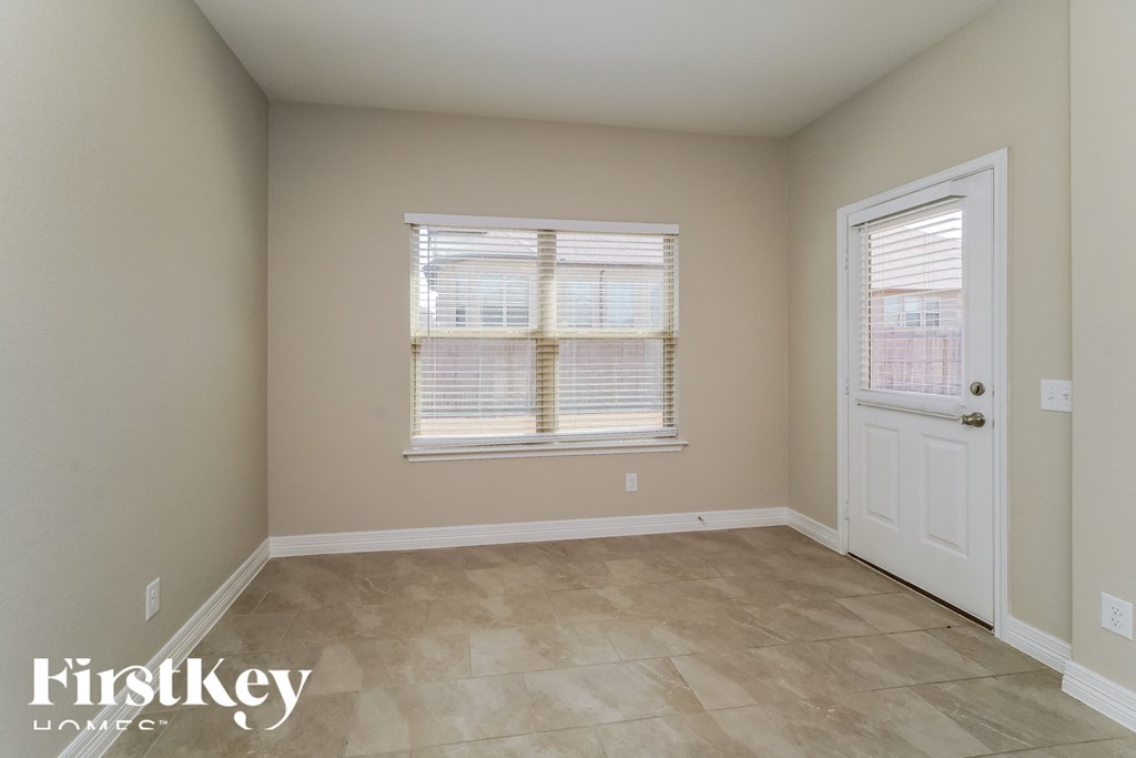 a bedroom with a door and a window and a tiled floor