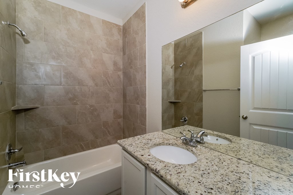 a bathroom with a sink and a tub and a shower