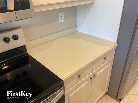 A kitchen with a stove top oven and a counter top.