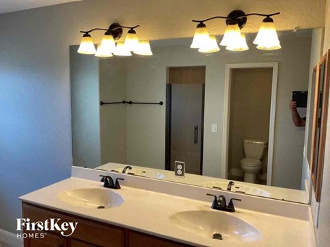 a bathroom with two sinks and a large mirror