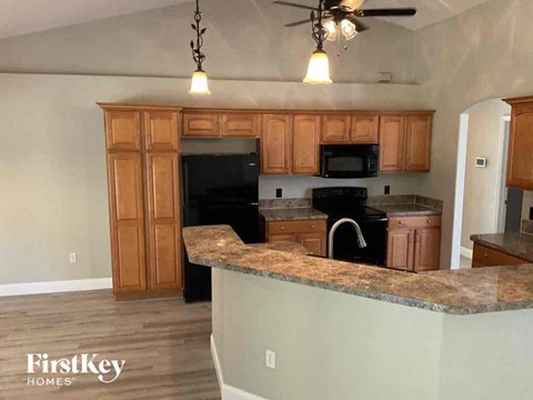 an empty kitchen with wooden cabinets and a counter top