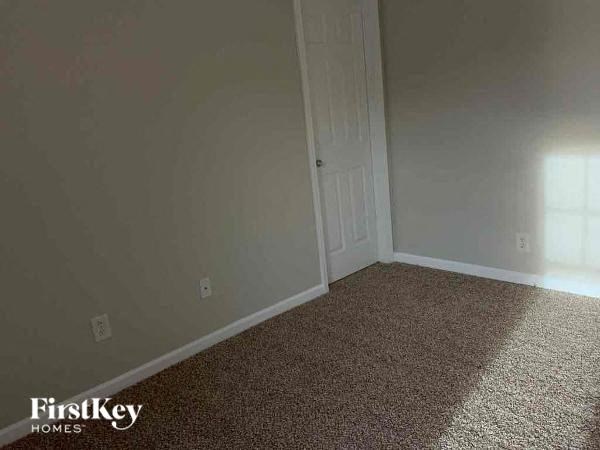 a empty room with a door and a carpet floor