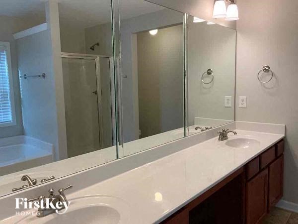 a bathroom with two sinks and a large mirror