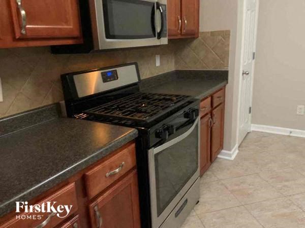 a kitchen with a stove and a microwave