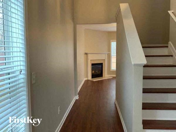 a living room with a staircase and a fireplace