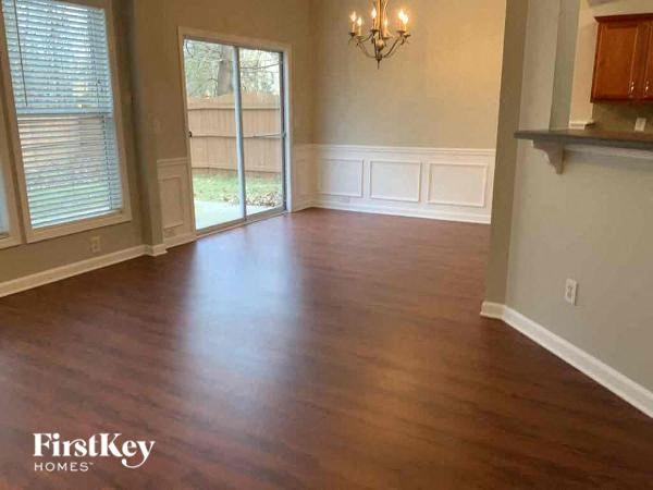an empty living room with a wood floor