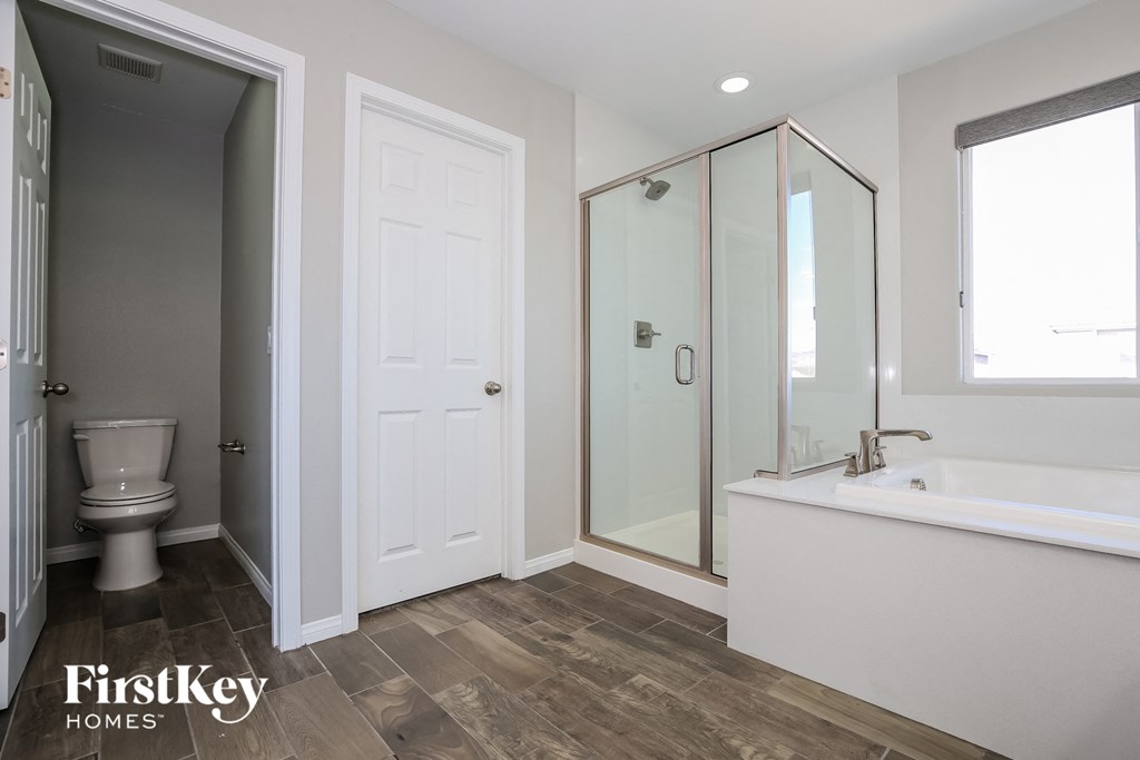 a bathroom with a toilet and a sink and a shower