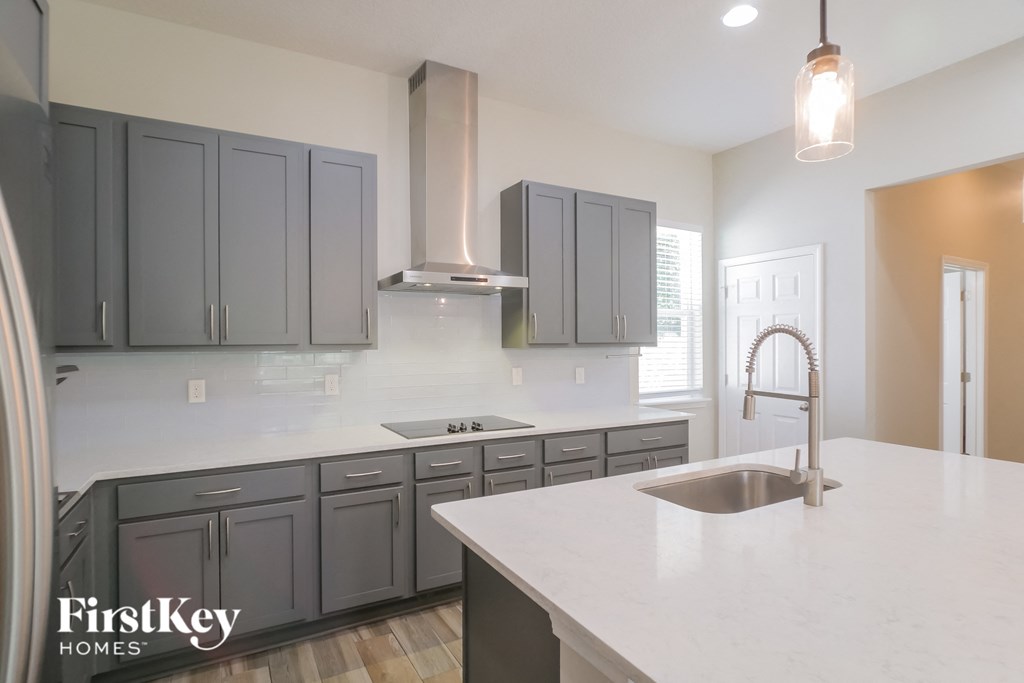 A kitchen with a sink and cabinets.