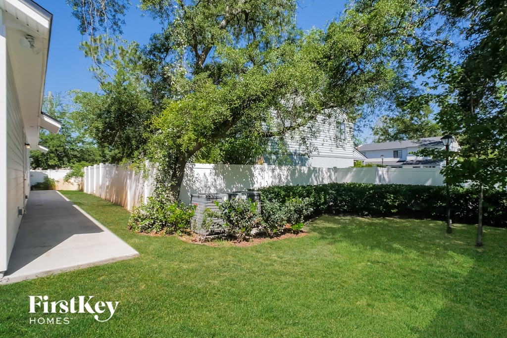 A well-maintained lawn and trees are visible in the image.