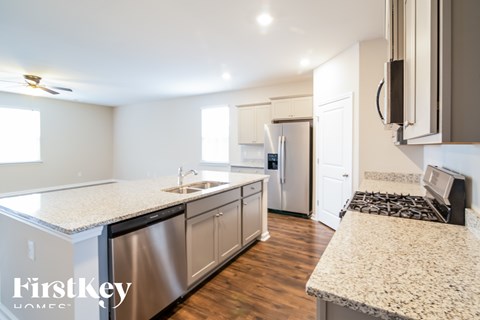A kitchen with granite countertops and stainless steel appliances.