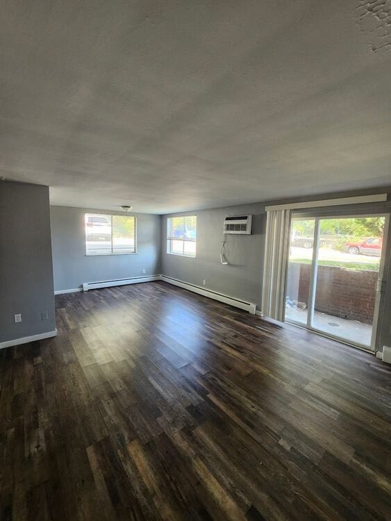 A room with wooden floors and a sliding glass door.