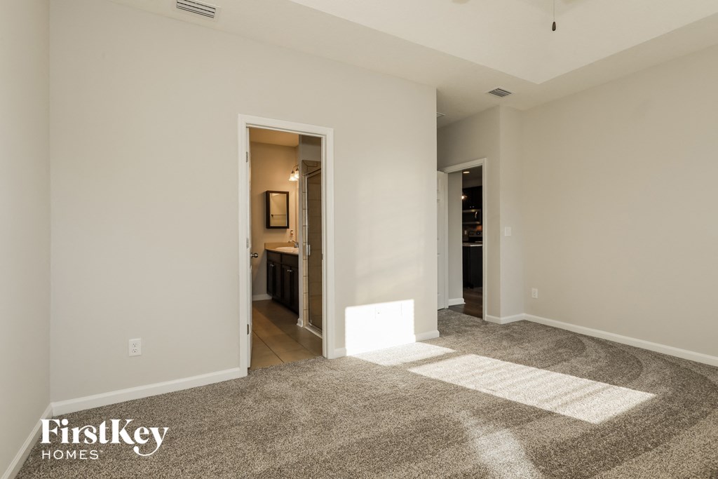 A room with a carpet and a painting on the wall.
