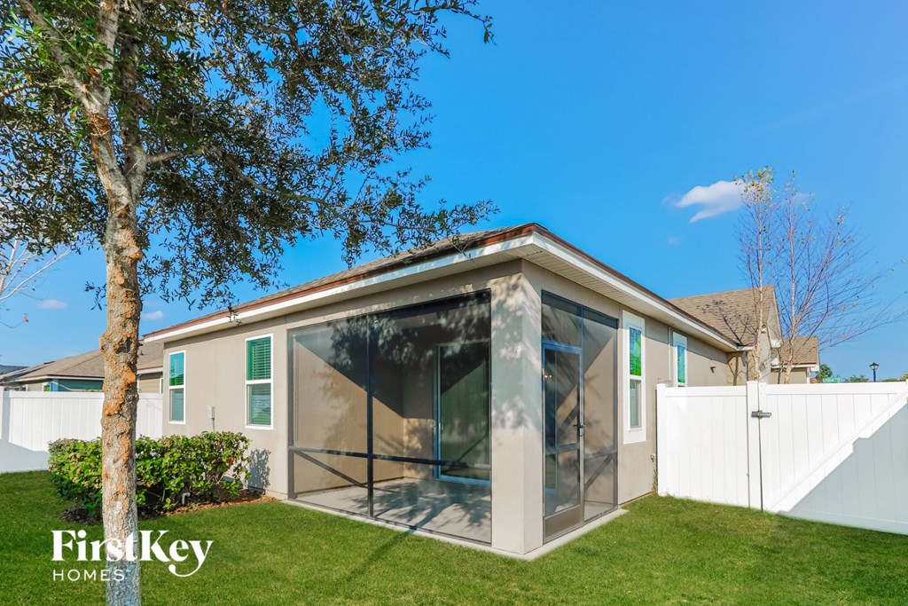 A house with a glass door and a tree in front of it.