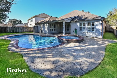 a backyard with a pool and a house