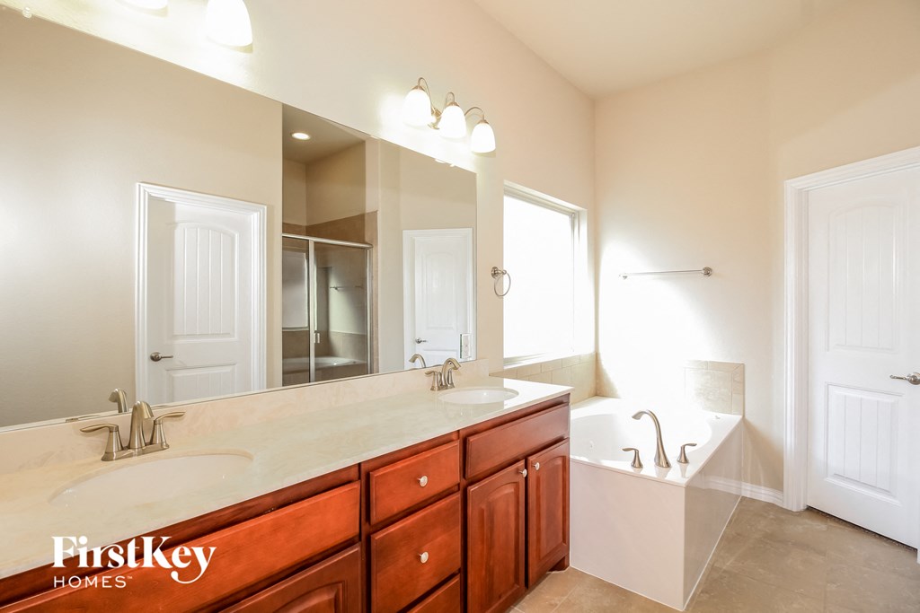 a bathroom with two sinks and a large mirror