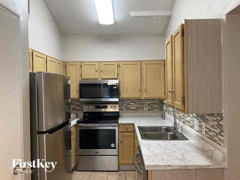 a kitchen with stainless steel appliances and wooden cabinets