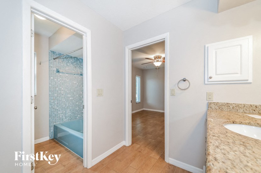 a bathroom with a shower and a sink and a mirror