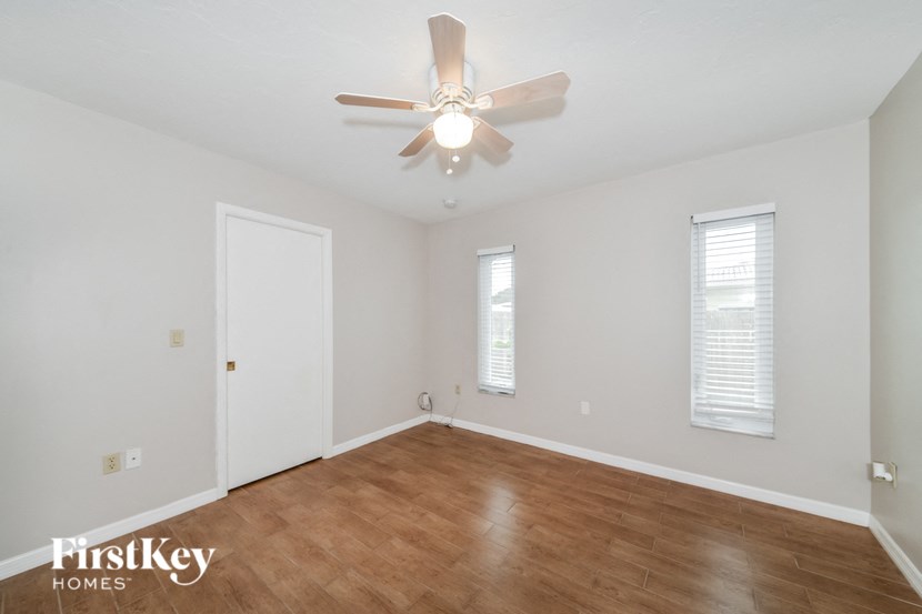 a living room with a ceiling fan and wood floors