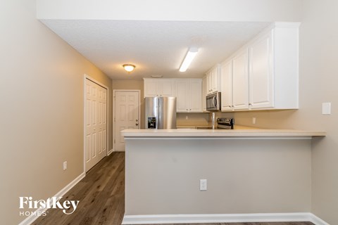 a kitchen with white cabinets and a counter top