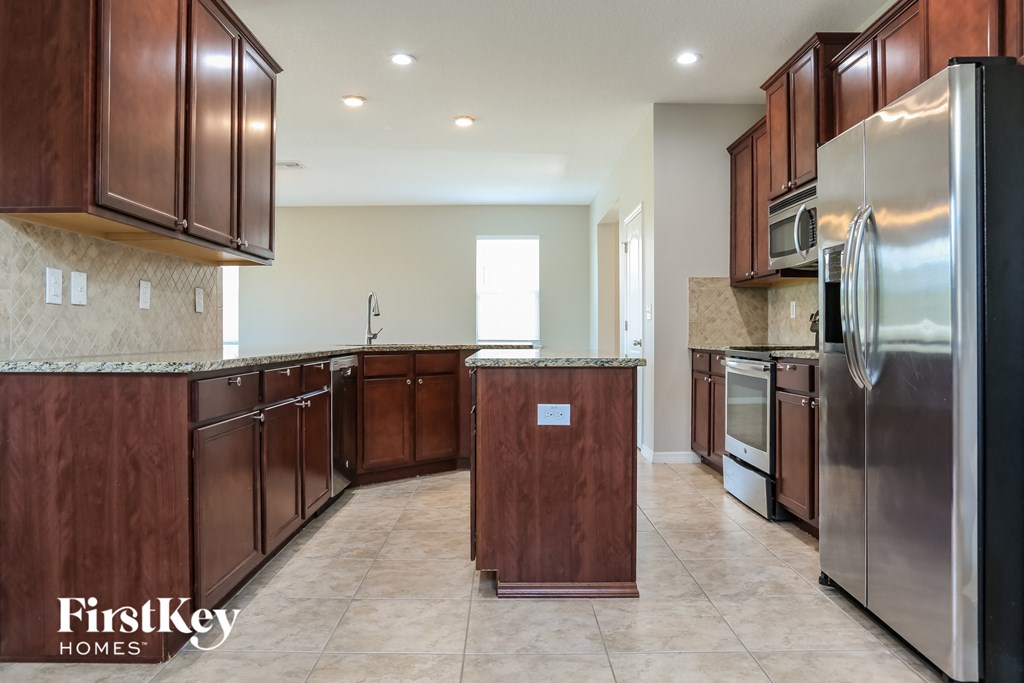 a kitchen with wooden cabinets and stainless steel appliances
