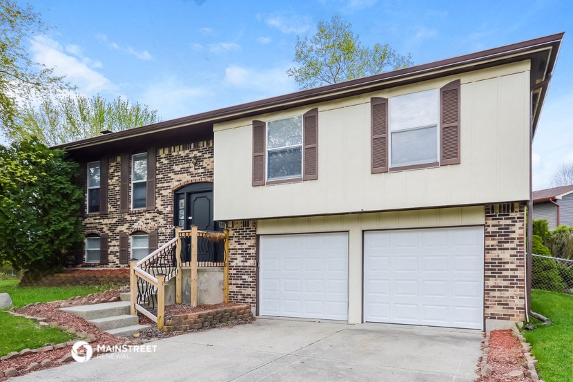 a brick house with a white garage door
