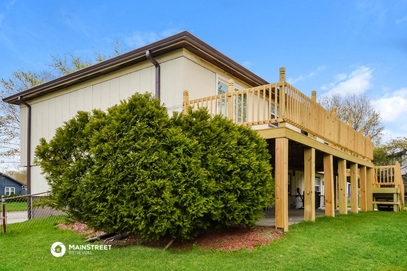 a cottage with a deck and a wooden deck
